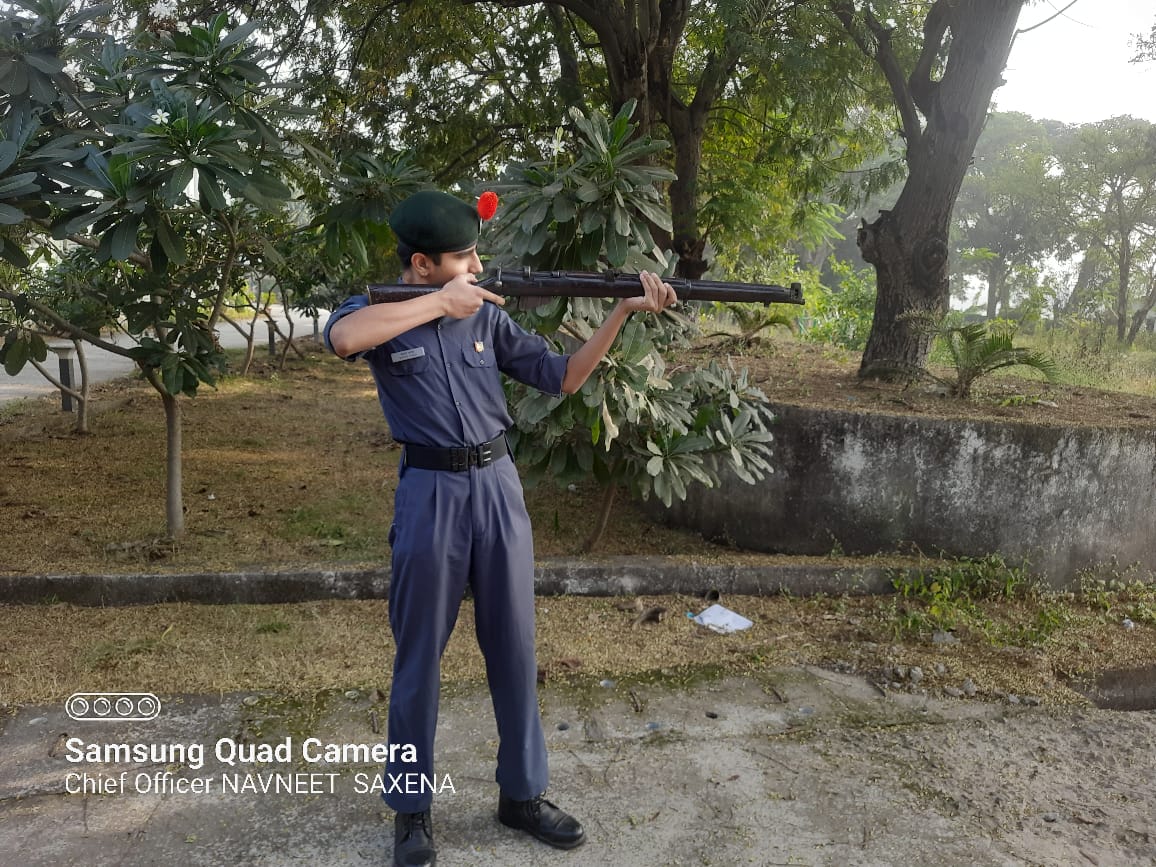NCC cadet in firing position with .22 rifle during weapons drill